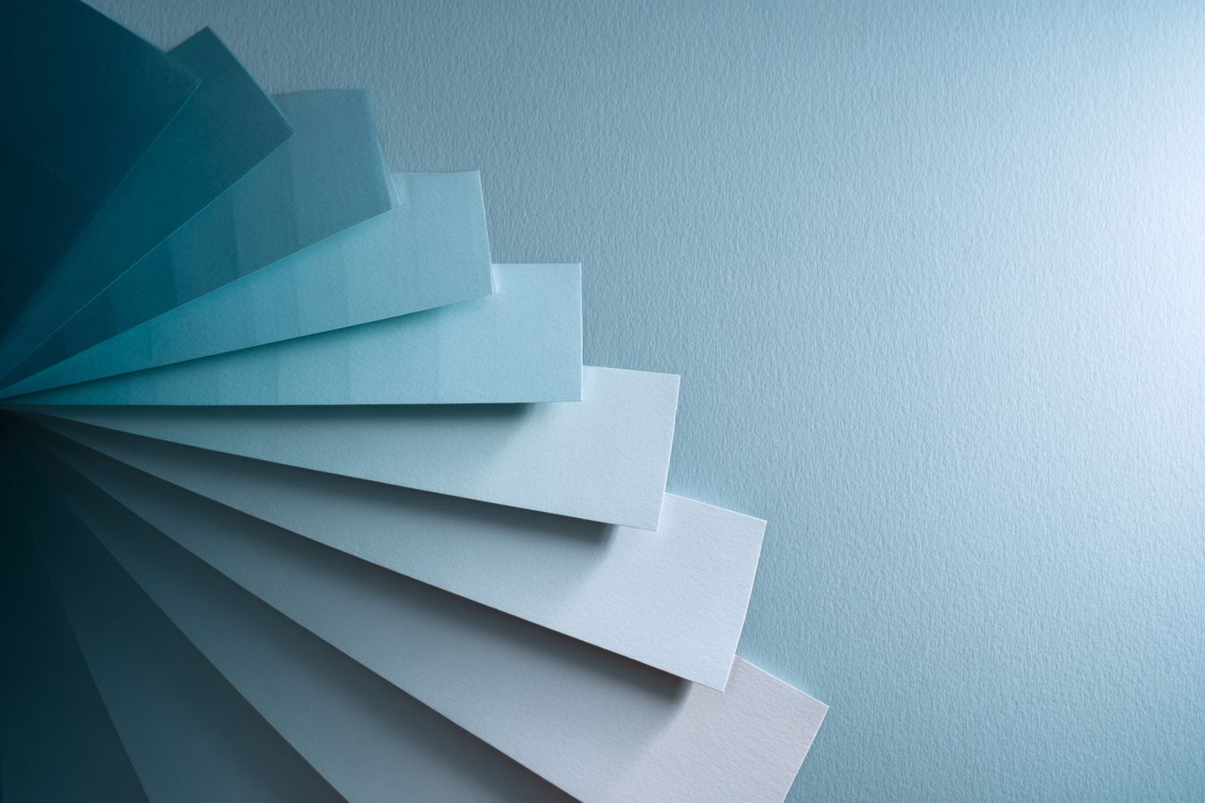 Fanned pale-blue paper swatches layered in a spiral