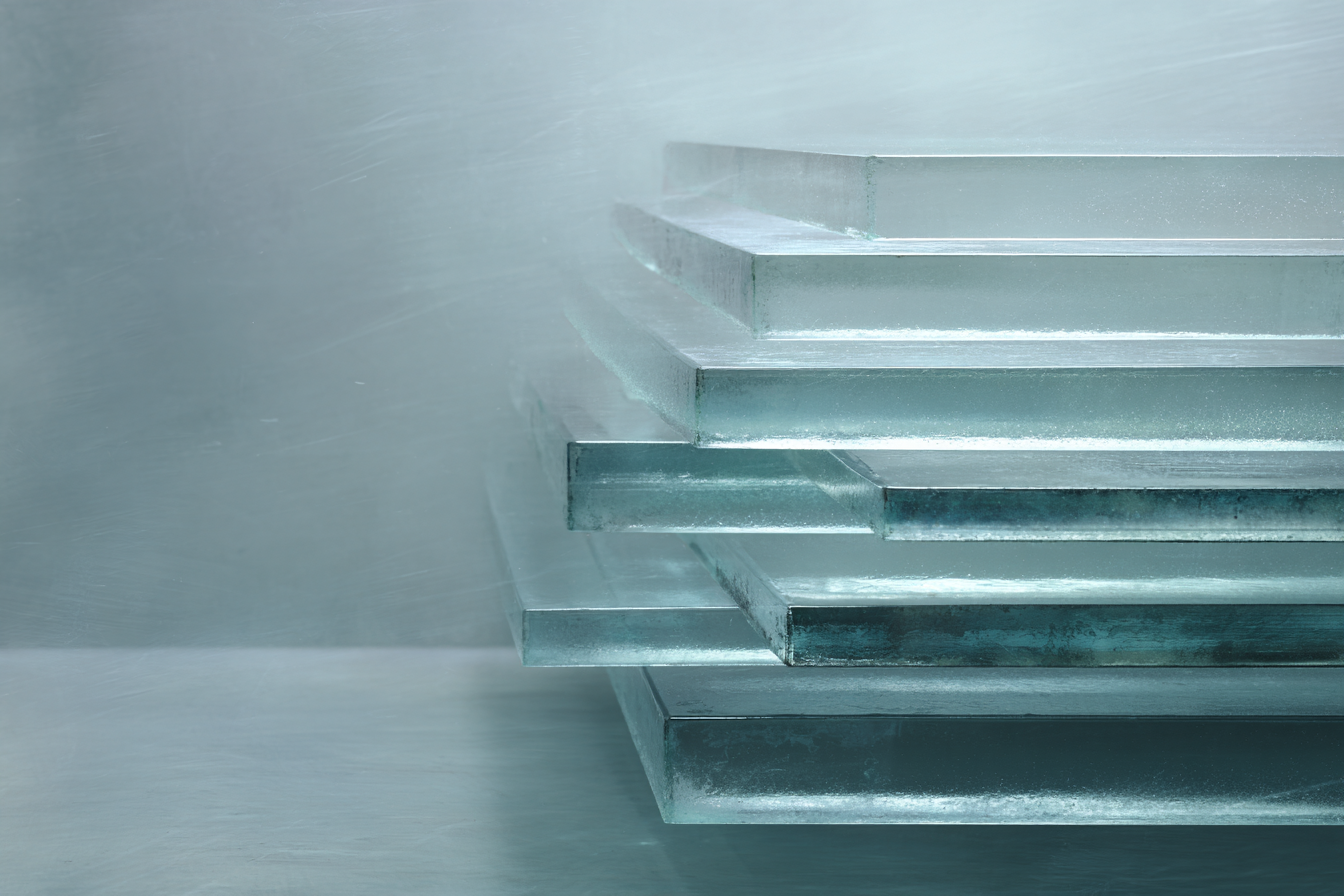 Layered translucent glass sheets in cool teal light