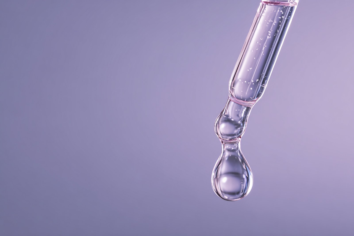 A glass dropper releasing a single clear serum droplet on a soft lilac background