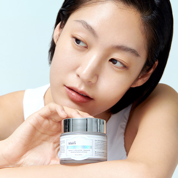 Model holding Freshly Juiced Vitamin E Mask jar for daily glow-care context