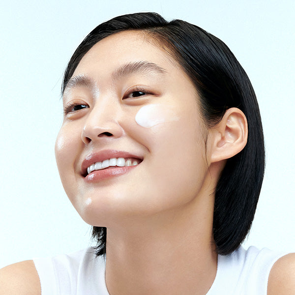 Model with radiant dewy skin representing Freshly Juiced Vitamin E Mask glow finish