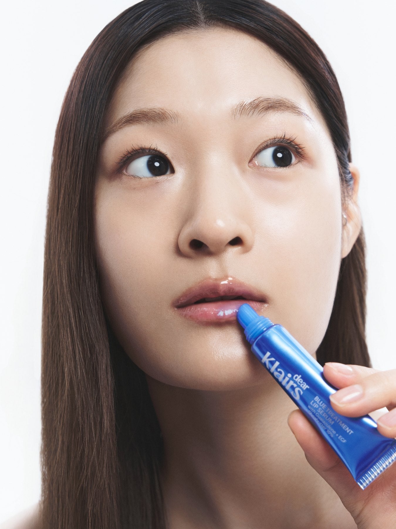 Applying Blue Treatment Lip Serum straight from the tube