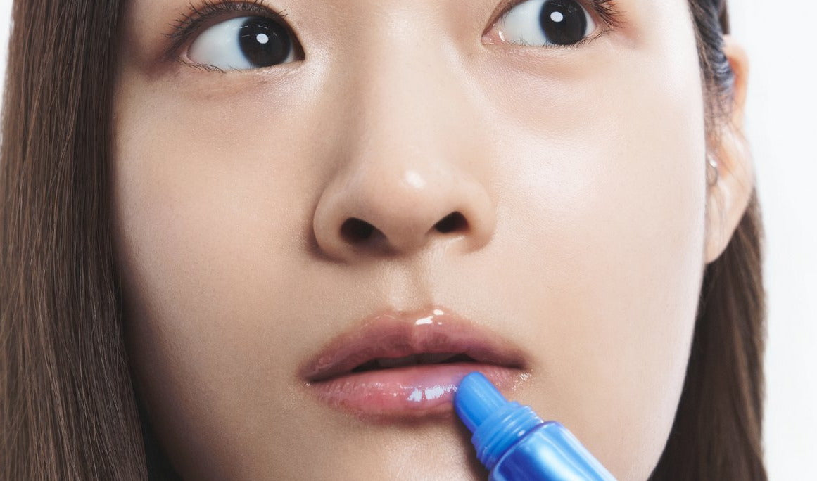 Applying Blue EGF Barrier Lip Balm straight from the tube